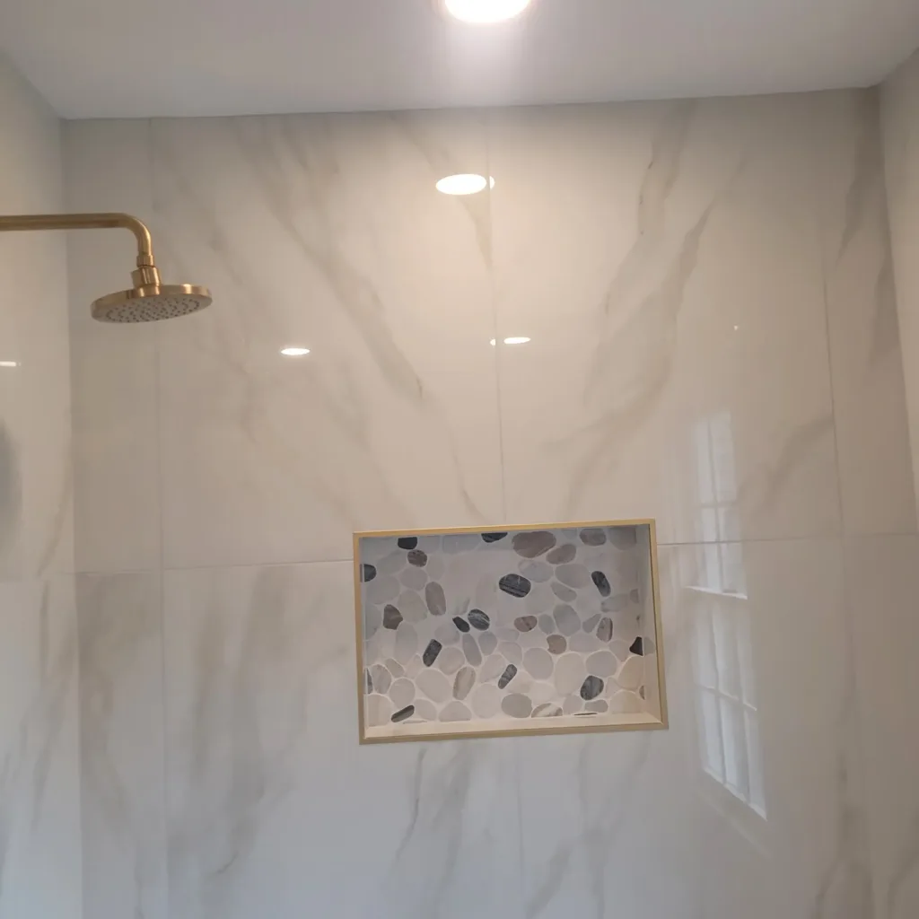 Bathroom remodel in New Jersey — finished shower head and mosaic niche